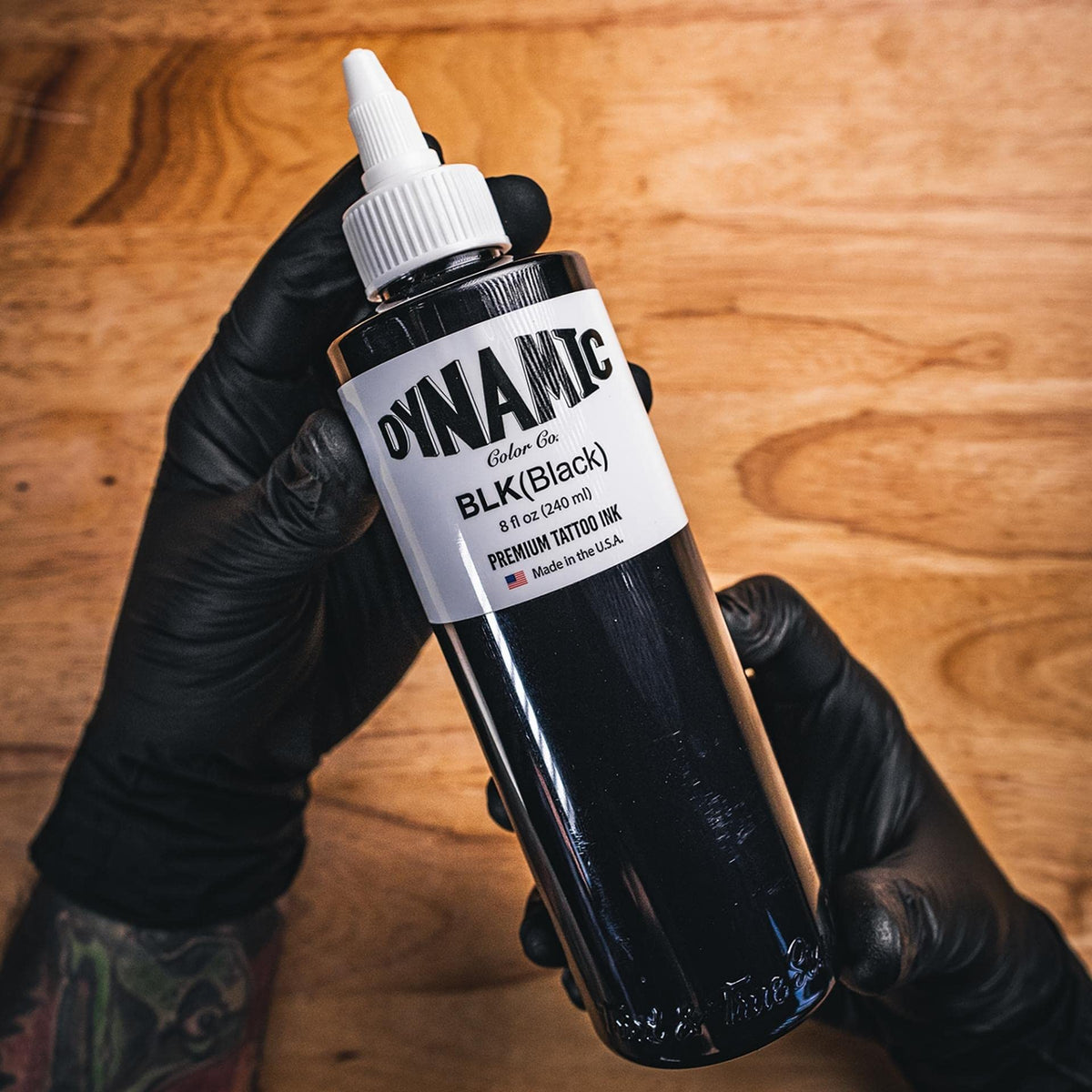Dynamic Color bottle in tattoo studio environment highlighting professional trustworthiness