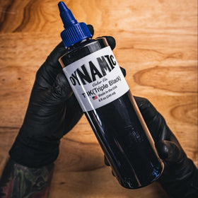 Dynamic Color Co bottle on tattoo station showing professional use and hygienic setup