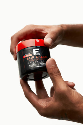 E Elegance jar next to hand for scale showing portable 8.45 oz size