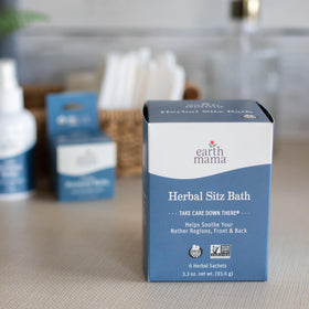 Hand holding sachet next to a sitz basin showing Earth Mama sachet size and scale