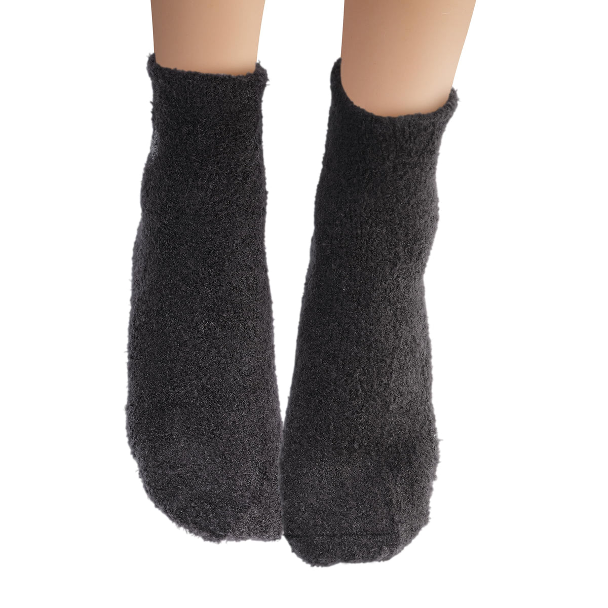 Earth Therapeutics aloe socks in lounge setting suggesting relaxed self-care