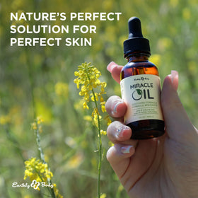 Earthly Body applying oil to hand for fast absorption and hydration benefit