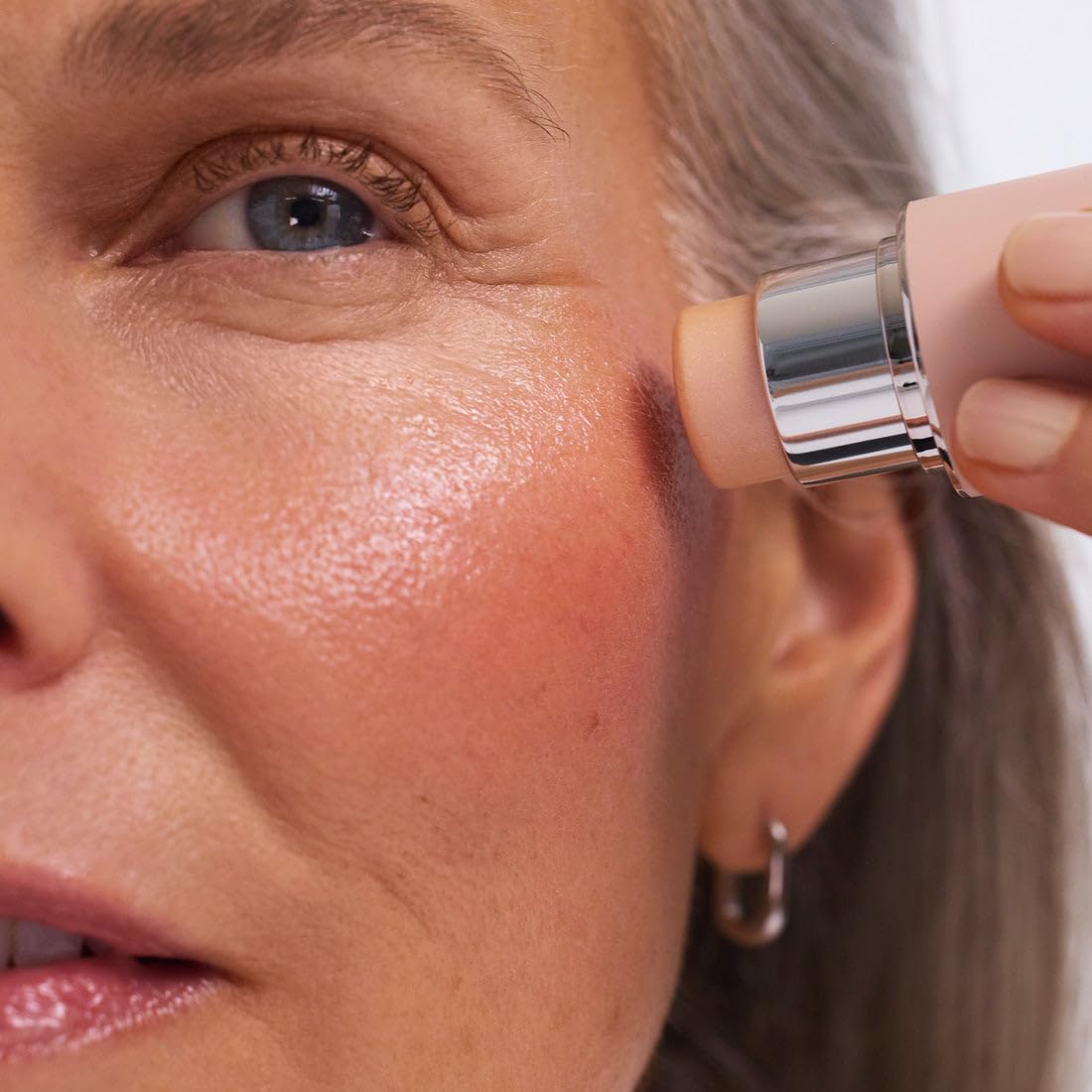 EarthsCure Glow Glaze applied on cheek illustrating natural luminous finish and subtle lift
