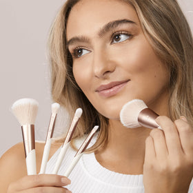 EcoTools brush set held in hand to show size and control for precise makeup application benefit