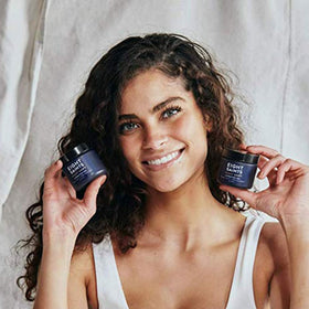 Eight Saints product in hand to show 2 ounce size and travel-friendly convenience