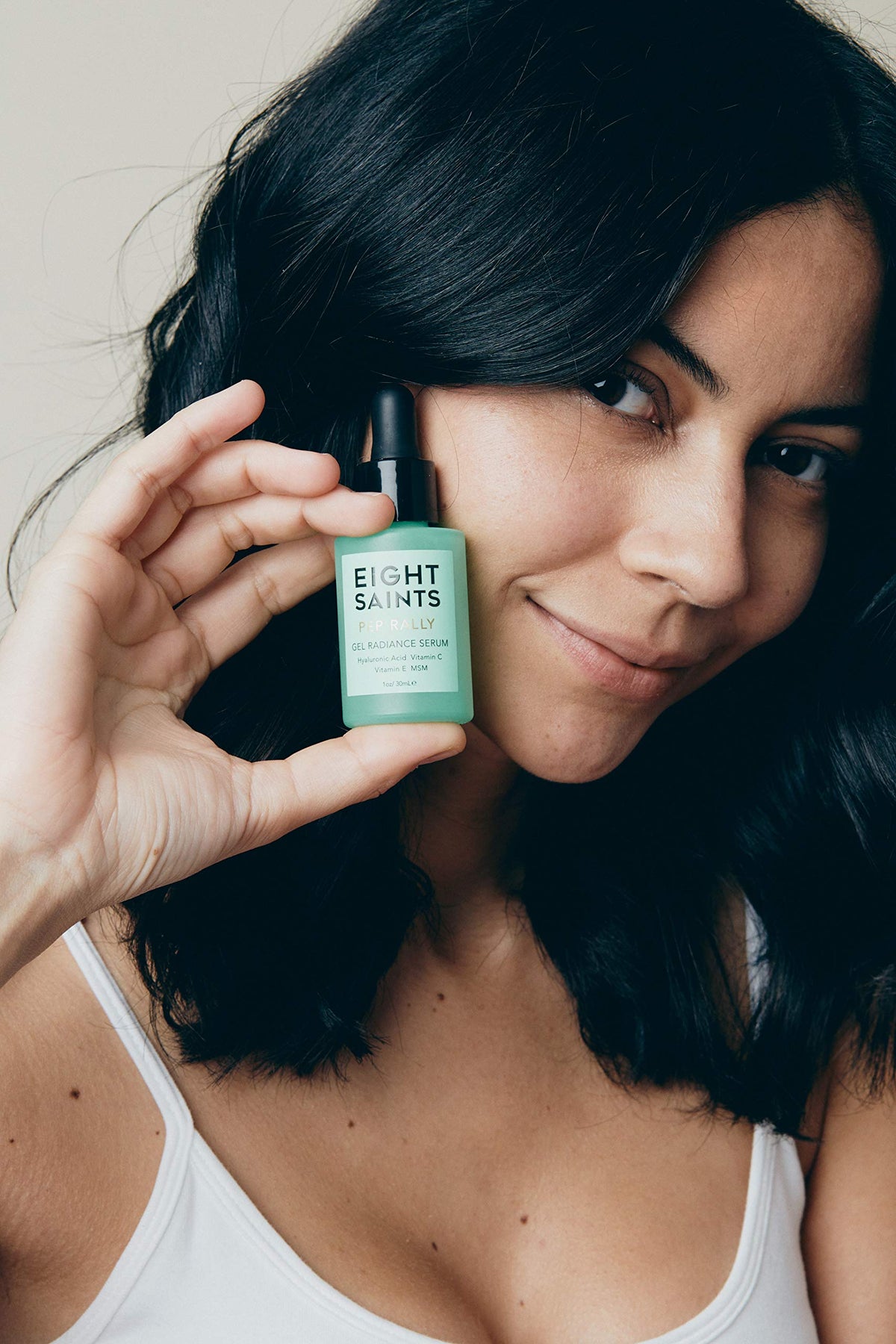 Eight Saints serum texture on fingertip demonstrating lightweight absorption
