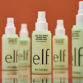 e.l.f. mist spraying on model for refreshed, natural-looking makeup finish