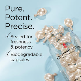 Elizabeth Arden capsule next to a coin for size comparison showing portable single-dose benefit