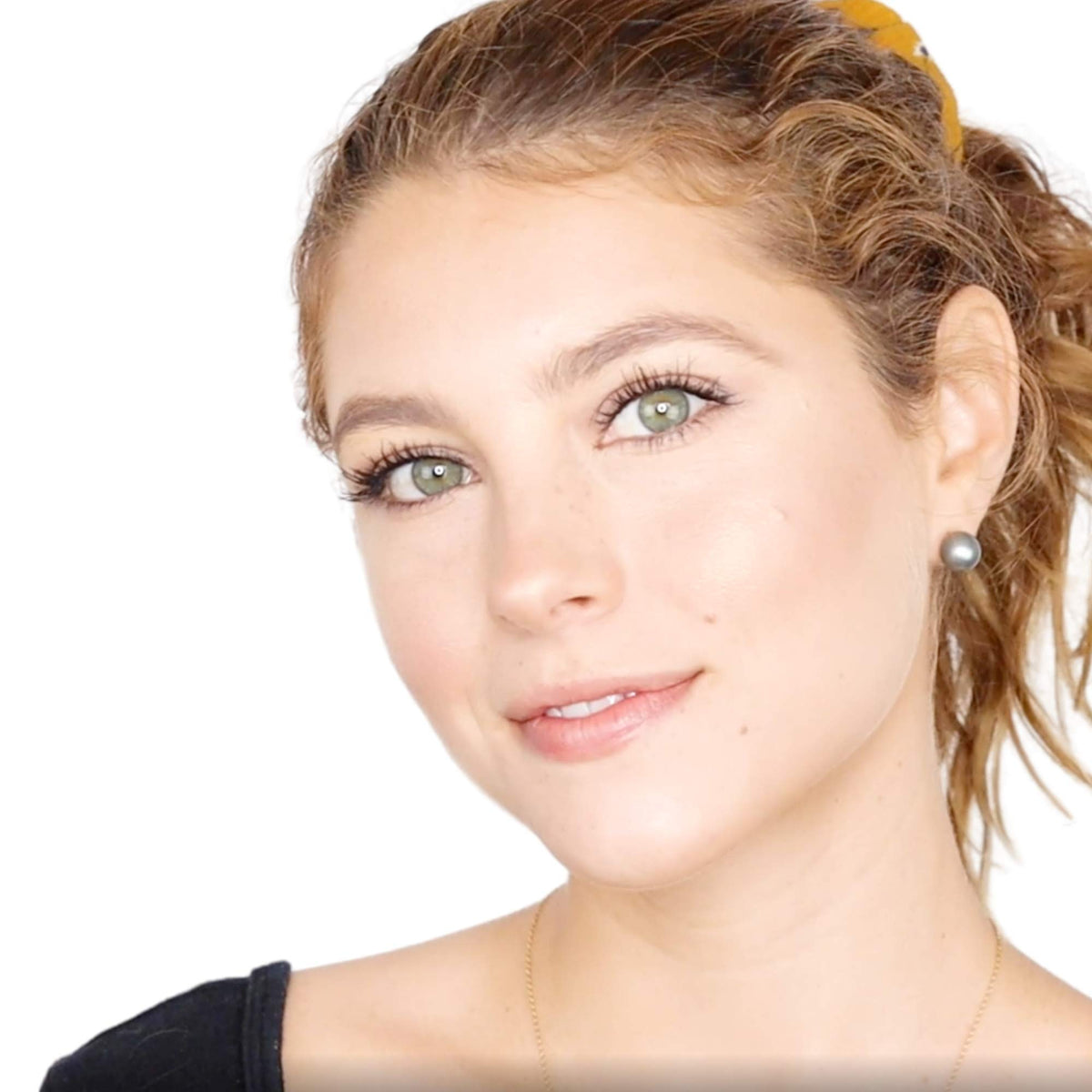 Elizabeth Mott brush applying bronzer to cheek for defined contour and blendability