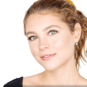 Elizabeth Mott brush applying bronzer to cheek for defined contour and blendability