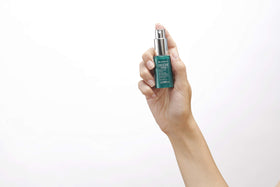 Endocare Tensage next to a coin for 15ml scale, illustrating portable travel-size convenience