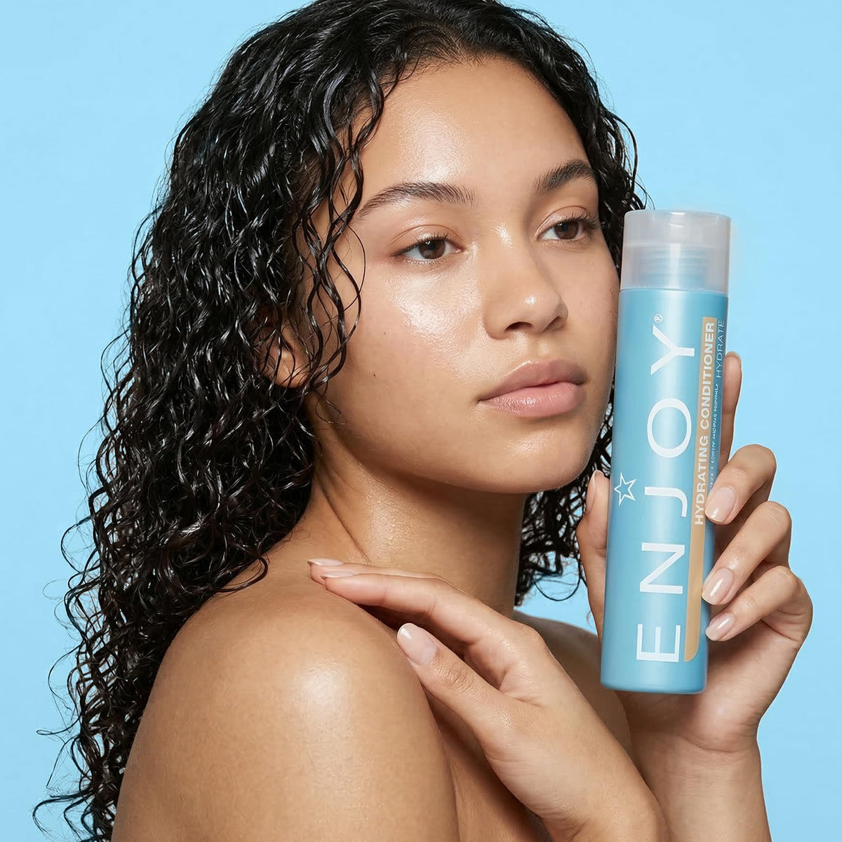 Enjoy conditioner on bathroom shelf lifestyle shot suggesting daily routine benefit