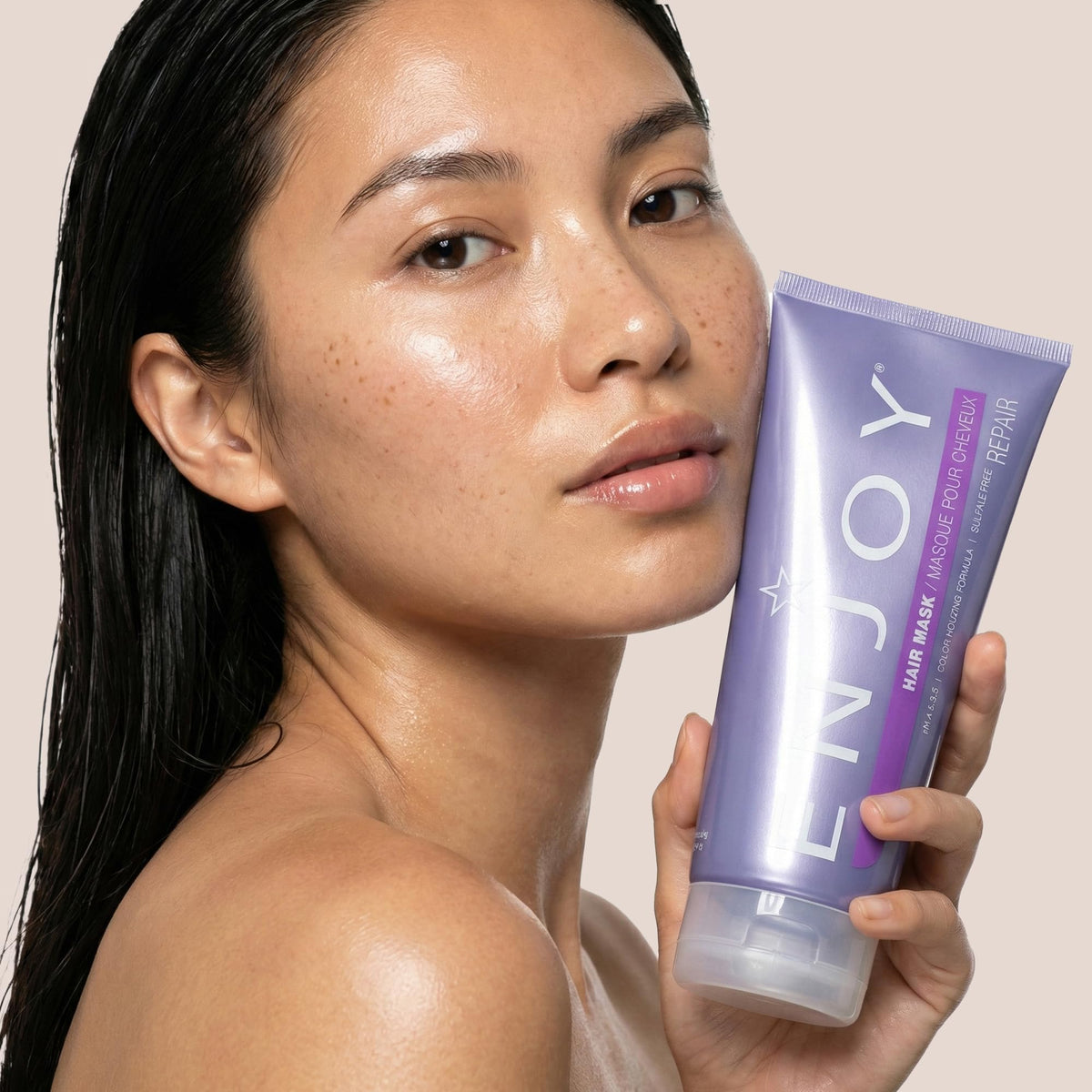 Enjoy hair mask on bathroom shelf styled with towels, evokes everyday routine ease
