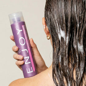 Enjoy creamy conditioner texture close-up showing richness and moisturizing benefit