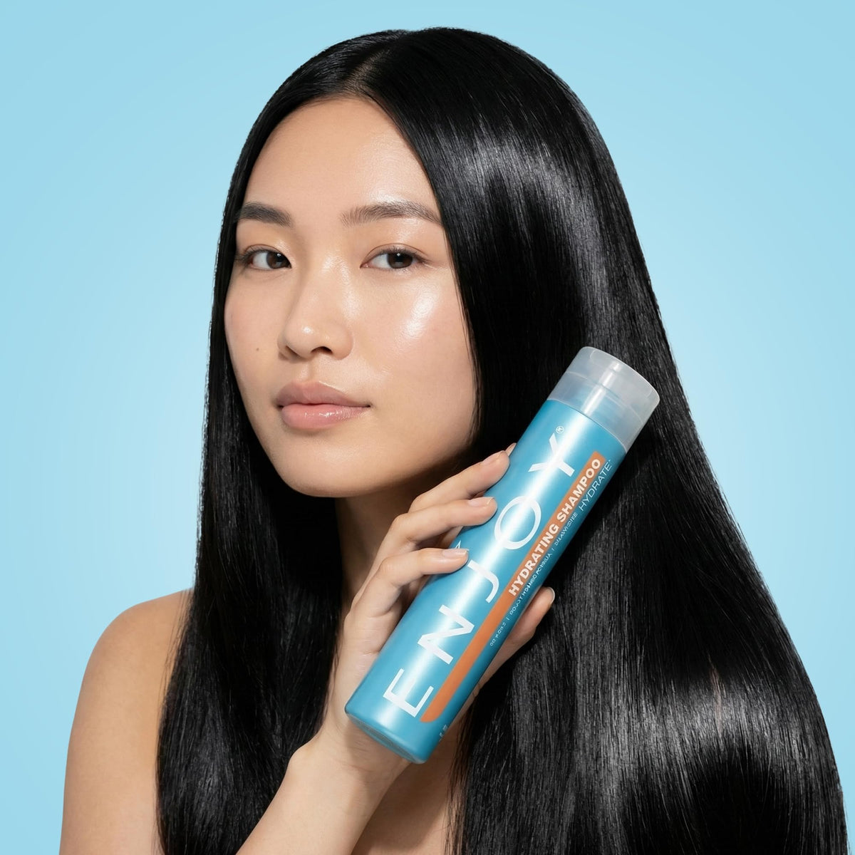 Enjoy size scale next to hand showing 10.1 fl oz travel-friendly benefit