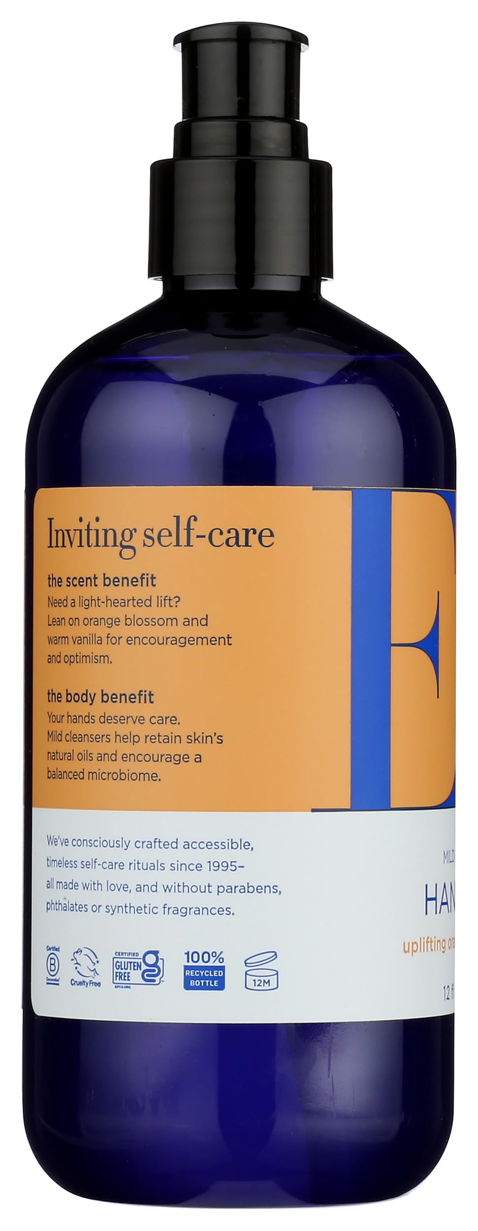 EO bottle next to hand to show 12 fl oz scale and single-hand dispensing