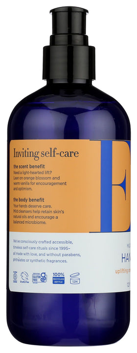 EO bottle next to hand to show 12 fl oz scale and single-hand dispensing