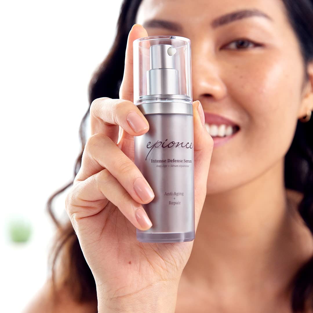 Person applying Epionce serum in mirror emphasizing youthful skin improvement