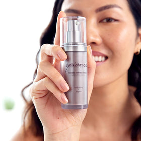 Person applying Epionce serum in mirror emphasizing youthful skin improvement