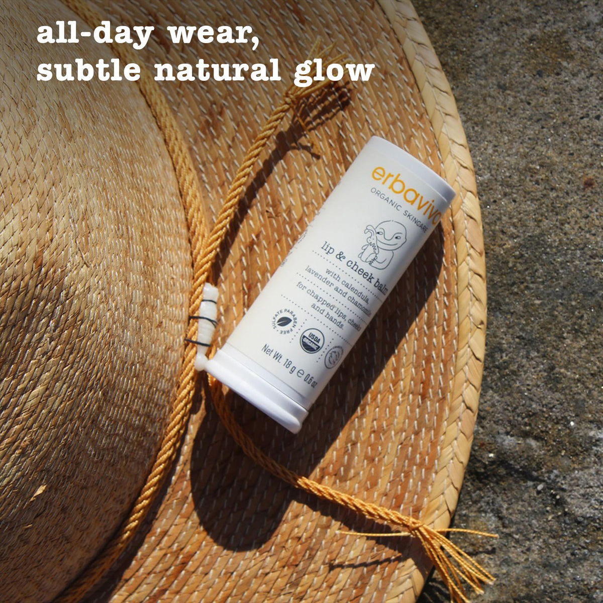 Erbaviva balm next to smartphone for scale showing pocket-friendly size