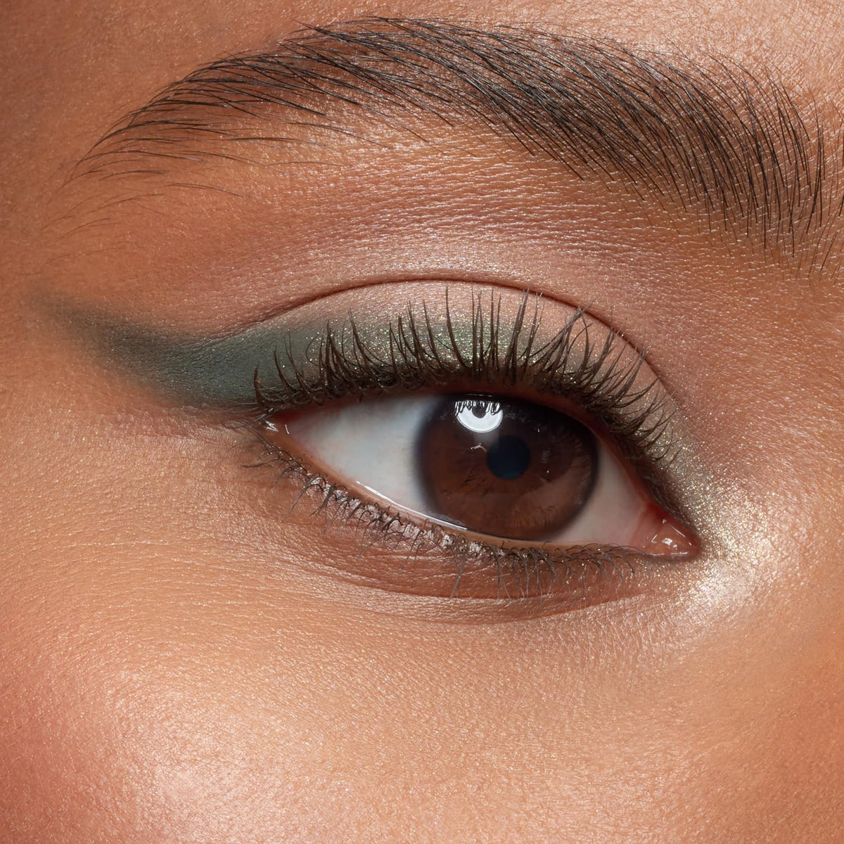 essence applying brown mascara to lashes for natural length and lift