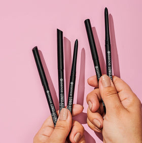 Essence Cosmetics eyeliner beside coin for size and travel-friendly scale