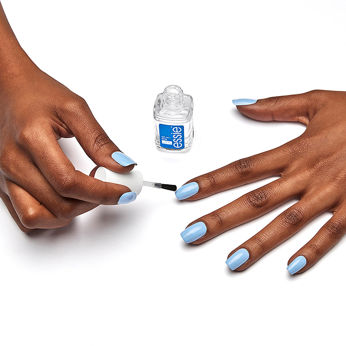 essie bottle held in hand to show compact size and travel-friendly benefit