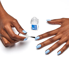 essie bottle held in hand to show compact size and travel-friendly benefit