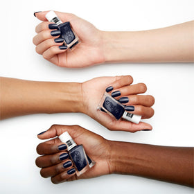 essie navy swatch on a fingertip showing true Caviar Bar color and rich pigmentation