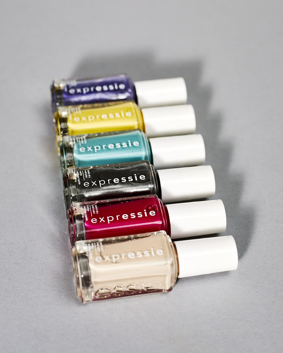flatlay with neutral outfit and essie Expressie showing style-friendly muted beige