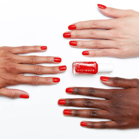 essie red swatch on a fingernail showing rich coverage and depth