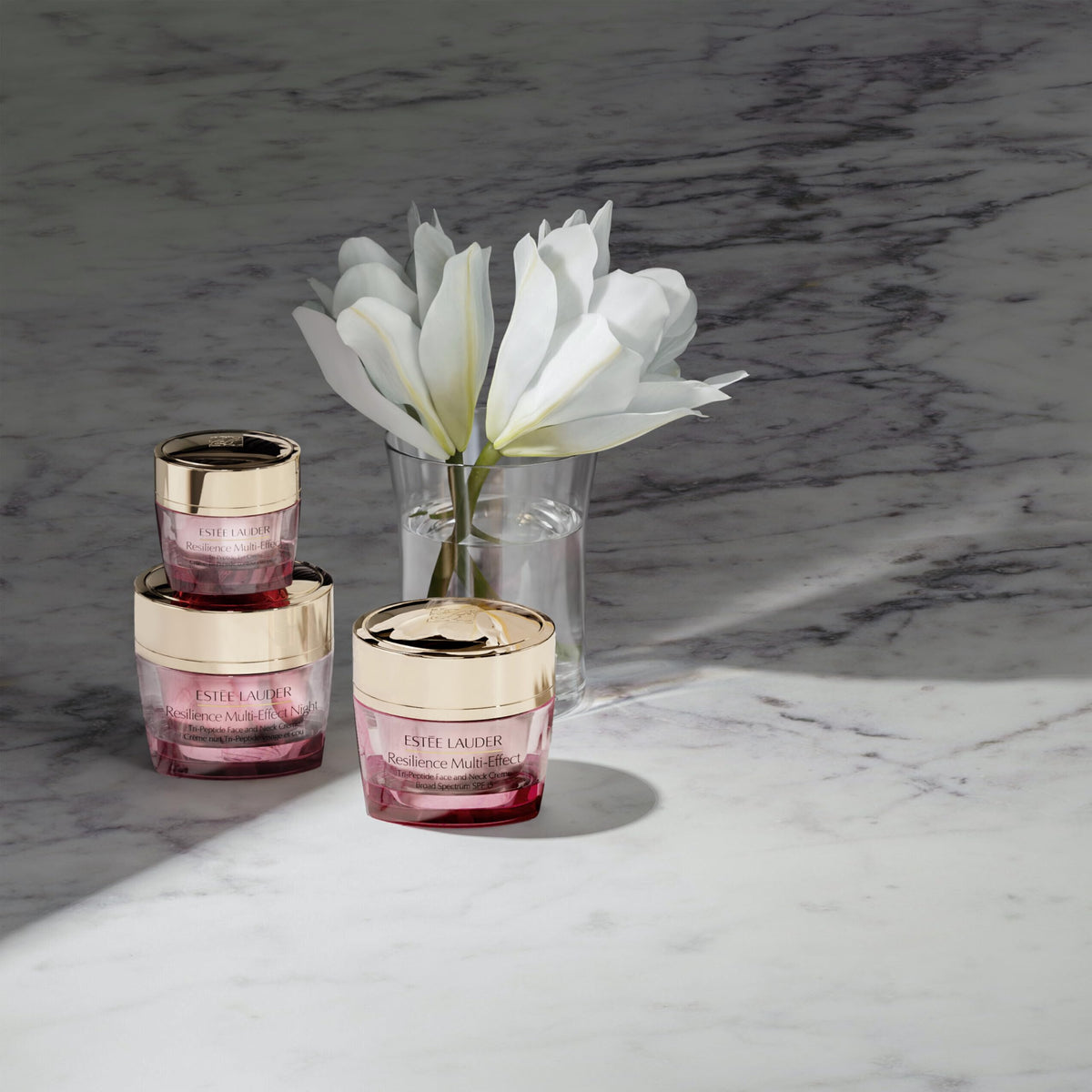 Estée Lauder 0.5 ounce jar beside common object showing true size