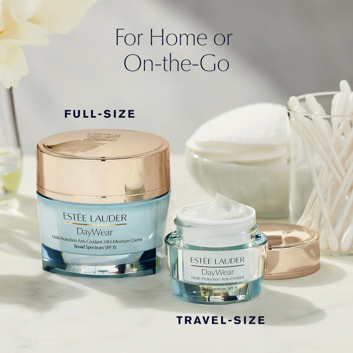 Estée Lauder jar beside lipstick for scale showing compact travel-friendly benefit