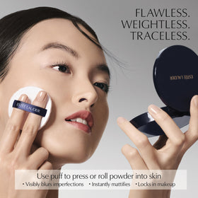 Estée Lauder puff pressing powder onto skin demonstrating quick touchup benefit