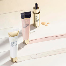 Estée Lauder primer next to common items showing 1.35 fl oz scale for travel convenience