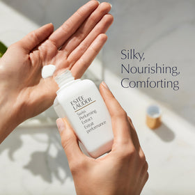 Estée Lauder product held in hand to show 3.4 oz scale and portability