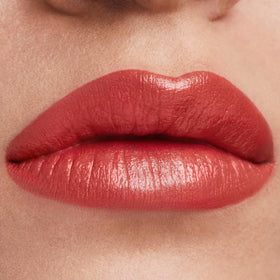 Estée Lauder swatches on skin showing frosted apricot shimmer and buildable coverage benefit