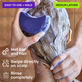 Ethique purple shampoo bar with ingredients spread showcasing natural botanicals