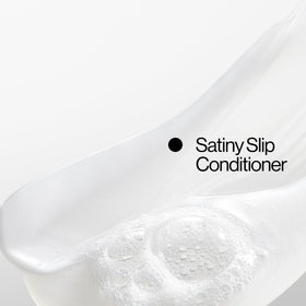 EVA·NYC bottle styled on bathroom shelf showing salon-finished shine benefit