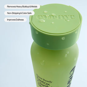 EVA·NYC 10 fl oz bottle next to a ruler for scale to show portable weekly-use size