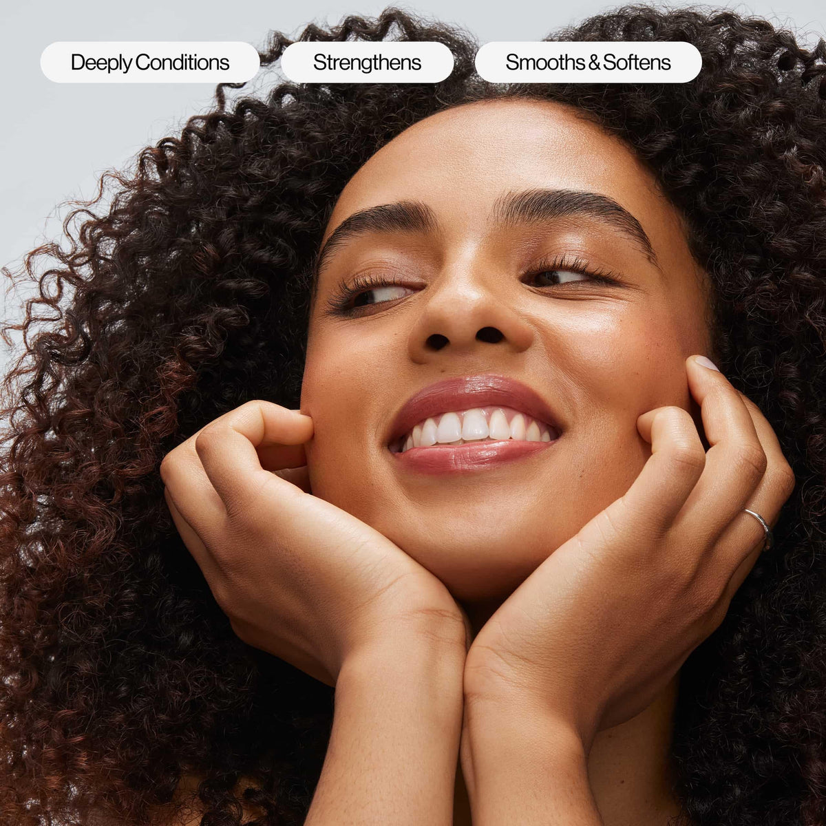 EVA·NYC applying mask to wet hair demonstrating improved manageability
