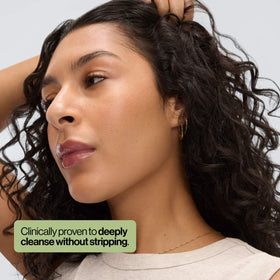 EVA·NYC shampoo in use on wet hair showing scalp massage for buildup removal benefit