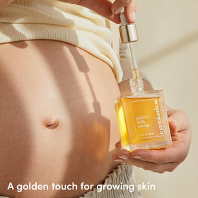 Evereden applying serum to pregnant belly for soothing hydration