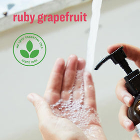 everyone ruby grapefruit foam texture on hand showing gentle lather and softening botanicals benefit: moisturized skin