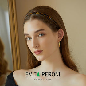 EVITA PERONI close-up of acetate texture highlighting glossy finish and flexibility