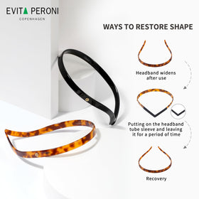 EVITA PERONI size comparison in hand showing slim profile and wearable scale