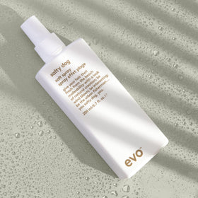 EVO bottle held in hand illustrating 6.8 fl oz size and travel-friendly benefit
