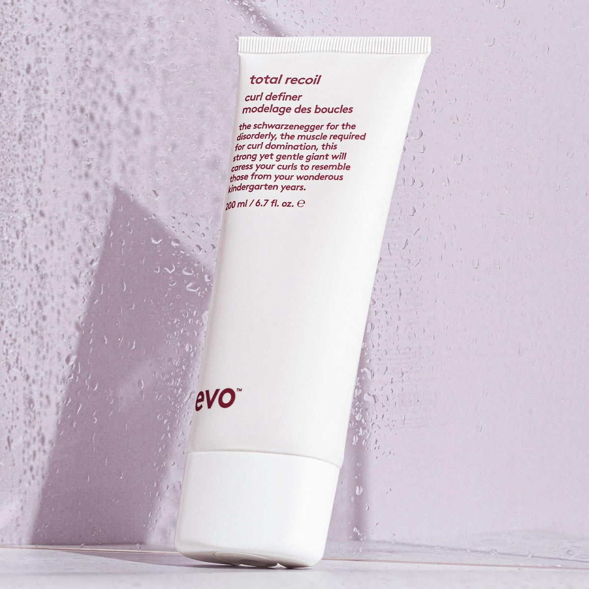 EVO product in use scrunching curls to show defined, frizz-free results