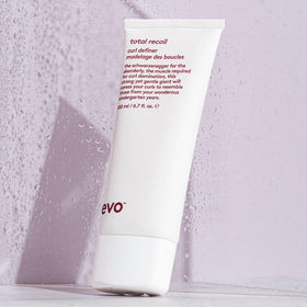 EVO product in use scrunching curls to show defined, frizz-free results