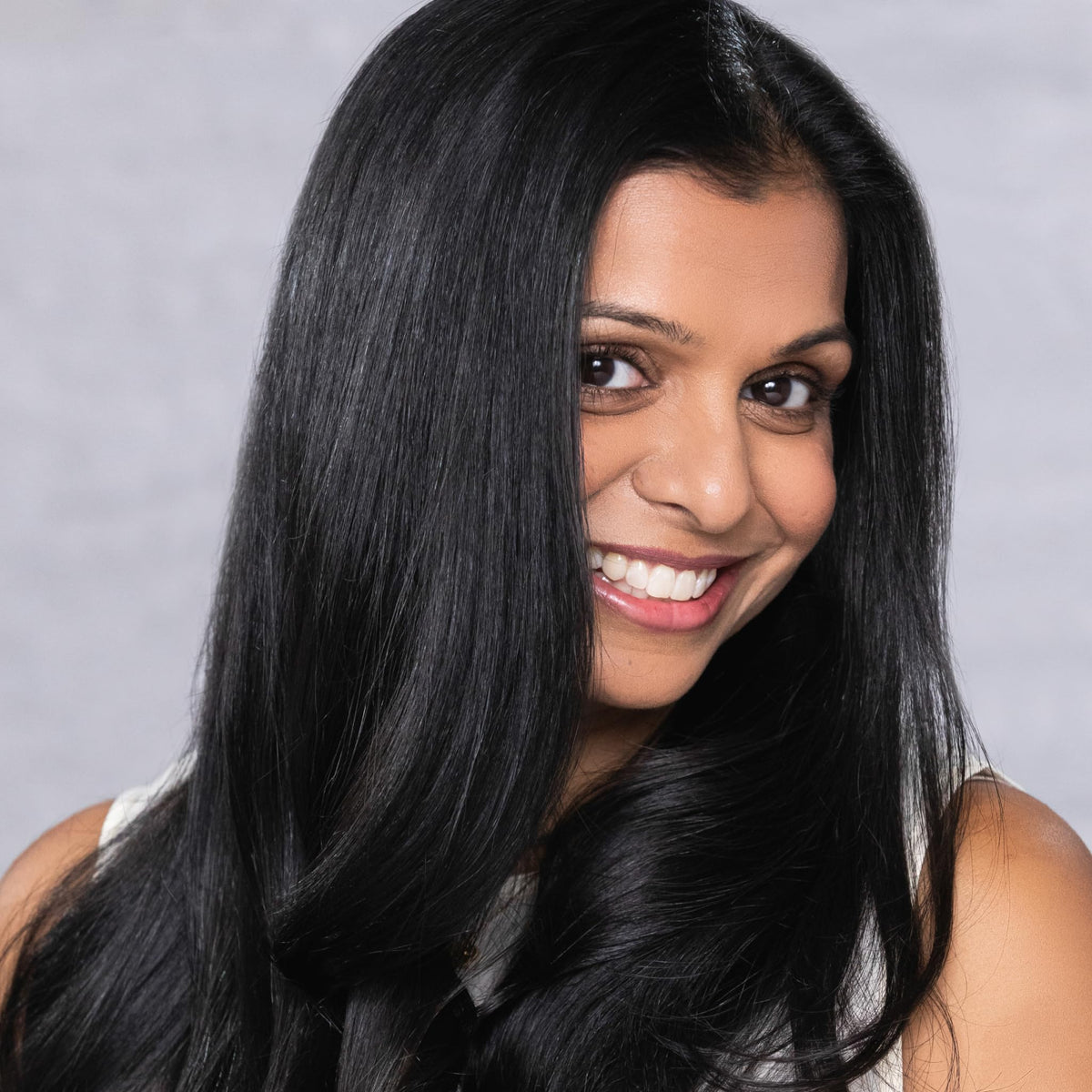 EVOLVh applied to wet hair in salon demonstrating smoothing action